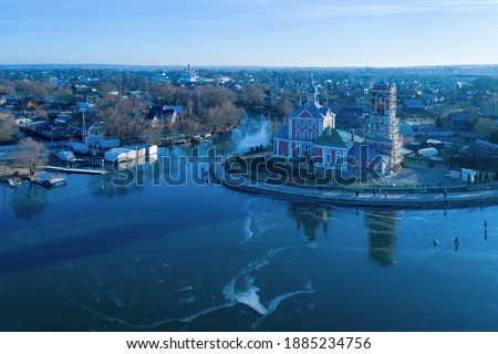 Aerial view of Church of the Forty martyrs and frozen lake Pleshcheyevo with skating people on it. Pereslavl-Zalessky, Yaroslavl Oblast, Russia.