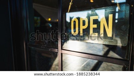 Open Sign at door of Small bossiness. 