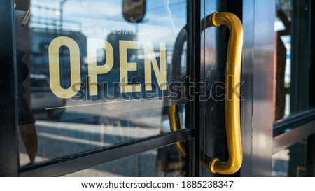 Open Sign at door of Small bossiness. 