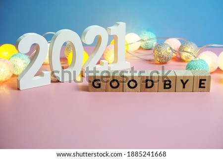 Goodbye 2021 word alphabet letters on wooden background
