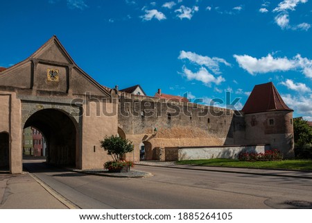 Big city gate through the big medieval city wall Royalty-Free Stock Photo #1885264105