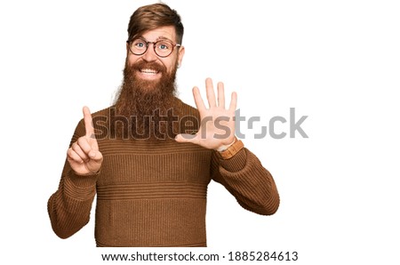 Young irish redhead man wearing casual clothes and glasses showing and pointing up with fingers number six while smiling confident and happy. 