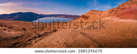 Panoramic view over Icelandic landscape of big volcanic caldera Askja, in the middle of volcanic desert in Highlands, with red, turquoise and orange volcano soil at sunset colors, Iceland