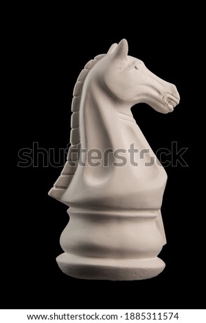 plaster figurine chess piece horse  black background