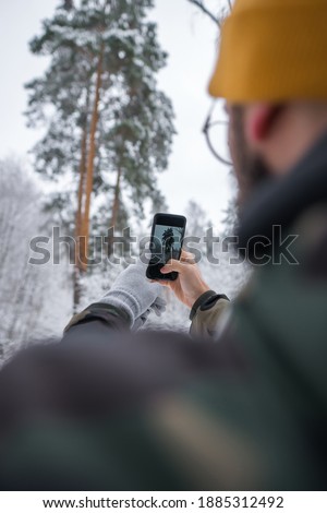 Young man take pictures of the nature.Travel concepts and technology
