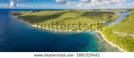 Aerial view above scenery of Curacao, Caribbean with ocean, coast, hills 
