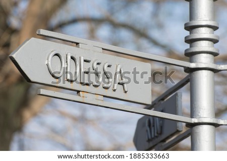 Street sign indicating the direction to the city of Odessa, Ukraine.