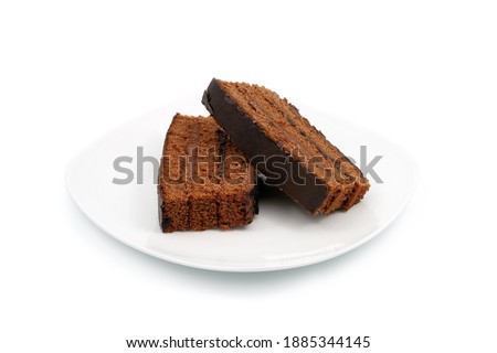 Pieces of cake on a white plate. Close-up. Isolated on white background.