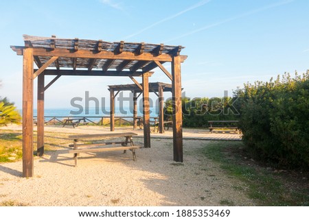Picnic area near the sea. Wooden structure. Beautiful spot to relax and have a snack.
