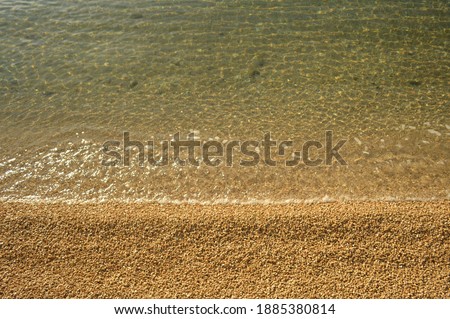 Sea waves on a gravel beach