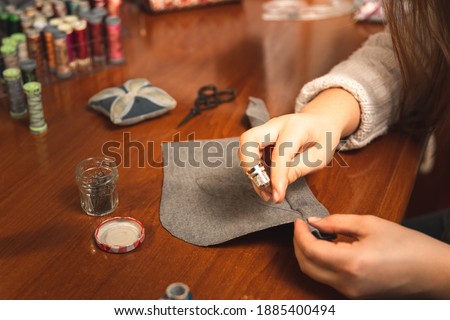Young dressmaker working on the studio with textiles
