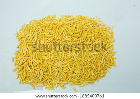 Sev is also used for garnishing  snacks. These crisp and . The most common version of sev is made with gram flour alone