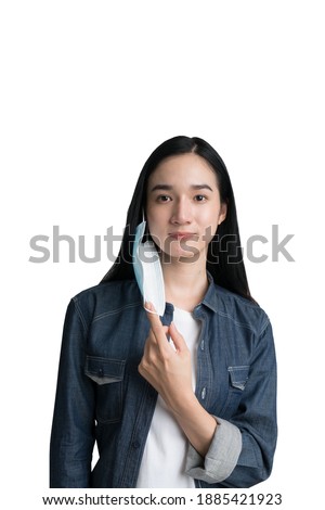 A beautiful woman removing a mask for virus protection with clipping path