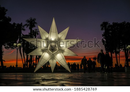 Christmas star illuminated in the square of sirmione at sunset. High quality photo