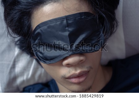 A man sleeping with sleep mask Royalty-Free Stock Photo #1885429819