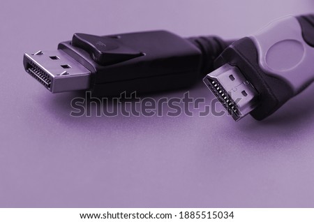 Audio video HDMI computer cable plug and 20-pin male DisplayPort gold plated connector for a flawless connection on a purple background Royalty-Free Stock Photo #1885515034