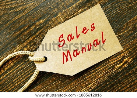 Business concept about Sales Manual with sign on the sheet.
