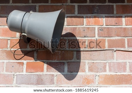 Megaphone in front of an old brick wall