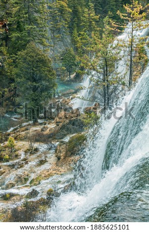 Colorful majestic long exposure waterfall in Jiuzhai valley national park forest during winter