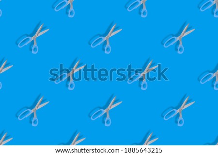 Seamless patterns. Seamless pattern from hairdressing scissors. Scissors on a blue background.