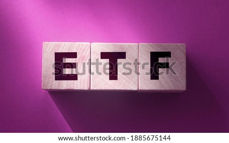 ETF, Exchange Traded Fund, realtime mutual index fund that can trade in equity stock market, cube wooden block with alphabet building the word ETF. Financial concept
