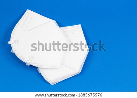 some particle filtering half masks isolated on blue background