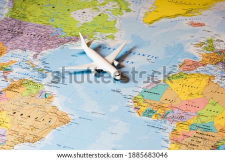 Travel the world. Travelling by plane. Airplane on a world map. Royalty-Free Stock Photo #1885683046