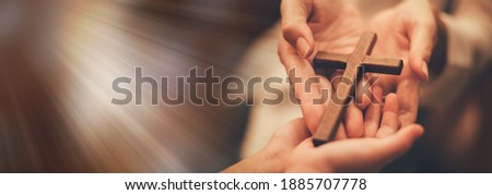 Woman's hand with cross .Concept of hope, faith, christianity, religion, church online. Royalty-Free Stock Photo #1885707778