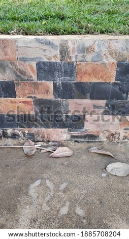 Texture of marble tiles and stone brick on the facade of the wall.