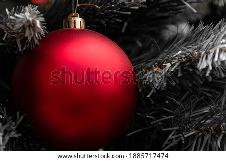 Macro view of a red Christmas ball with a bit of dust. Colours: red, gold and silver. Christmas card concept. Christmas greeting card 2021, 2022. Colours matt and glossy, space for copy-space
