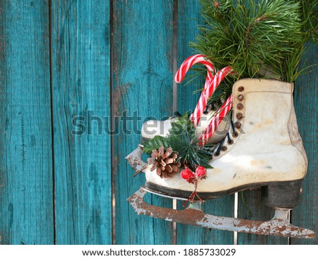 Flat lay with ice skates and christmas toys on wooden background