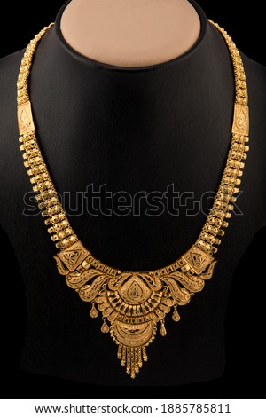 Indian style beautiful gold neckless isolated on black background. Royalty-Free Stock Photo #1885785811