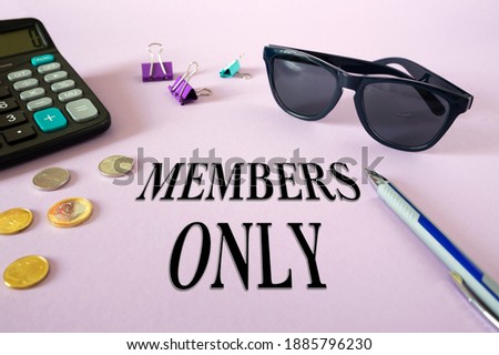 Text writing MEMBERS ONLY. Calculator, money and glasses on the table