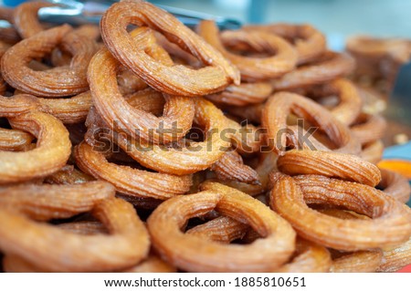 Turkish churros (Halka Tatlısı) a popular traditional street dessert made with crispy circles of deep fried dough with a soft centre dipped in a sweet sugary syrup