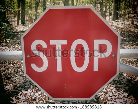 A filtered photo background of stop sign on a rural road.