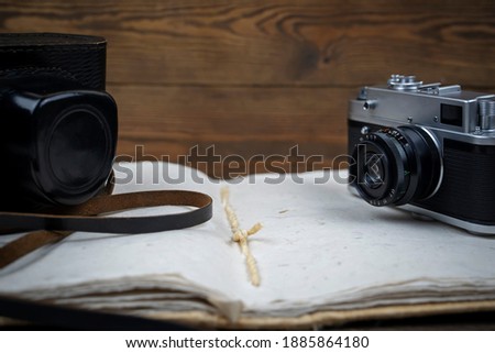 retro camera and photo album on a wooden background