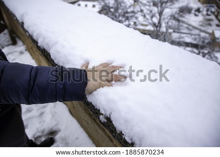 Hand resting on snow, cold and winter, Christmas