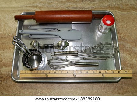 View of baking tools on a cookie sheet.