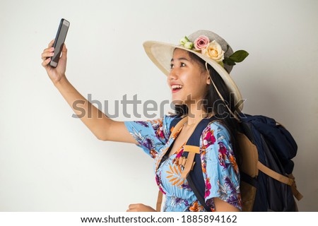 Asian woman tourist taking selfie isolated on white background