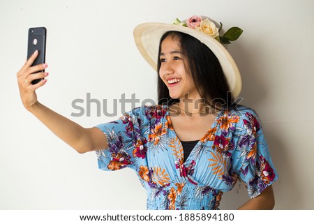 Asian woman tourist taking selfie isolated on white background