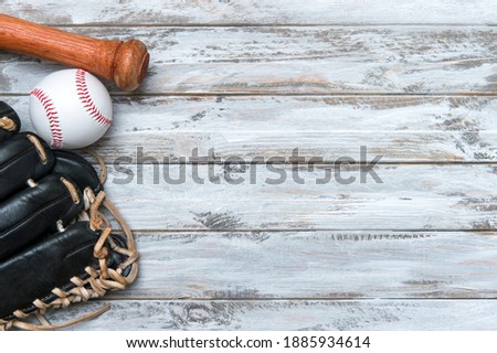 Baseball bat, glove and ball on wooden background.  Sport theme background with copy space for text and advertisment