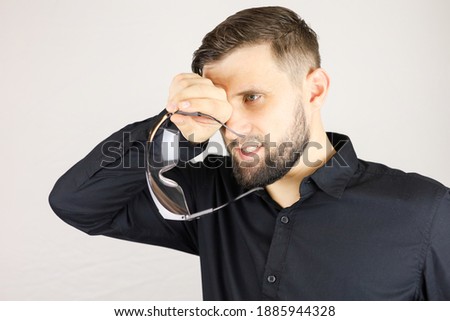 a man holds medical glasses in his hands