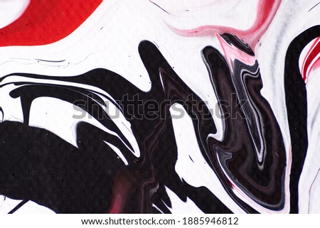Marbled acrylic colored pattern in the colors red, black, white and pink