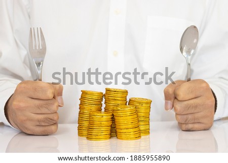 Men's hands with a spoon and piled up gold coins, business image, financial image