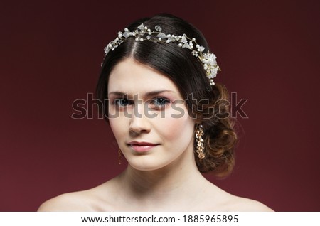 Beautiful young bride with fashion wedding hairstyle, close up picture over pink background