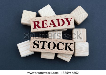 READY STOCK - words on wooden bars on cubes on a gray background. Business and finance concept