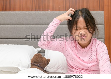 Girl itchy her hair or frustrated on bed, problem Health Hair concept