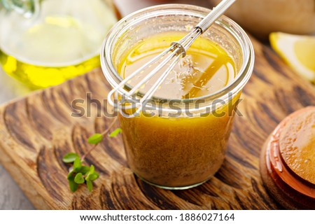 Homemade greek salad dressing or marinade in a glass jar Royalty-Free Stock Photo #1886027164