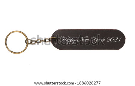 Leather keychain with Happy new yaer 2021 word isolated on white background. Brown Color , Happy new year label accessory chain with key 