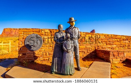 Great Seal of the Navajo Nation and Bronze Navajo Family Statue (with face mask) at the entrance of Monument Valley, which is closed due to COVID-19 pandemic. Royalty-Free Stock Photo #1886060131